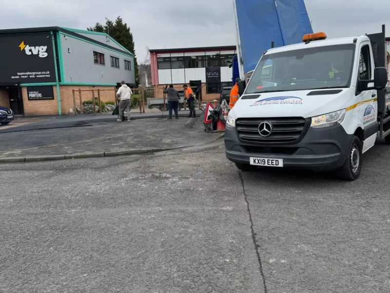 workers laying tarmac car park with WW Contracts van in foreground