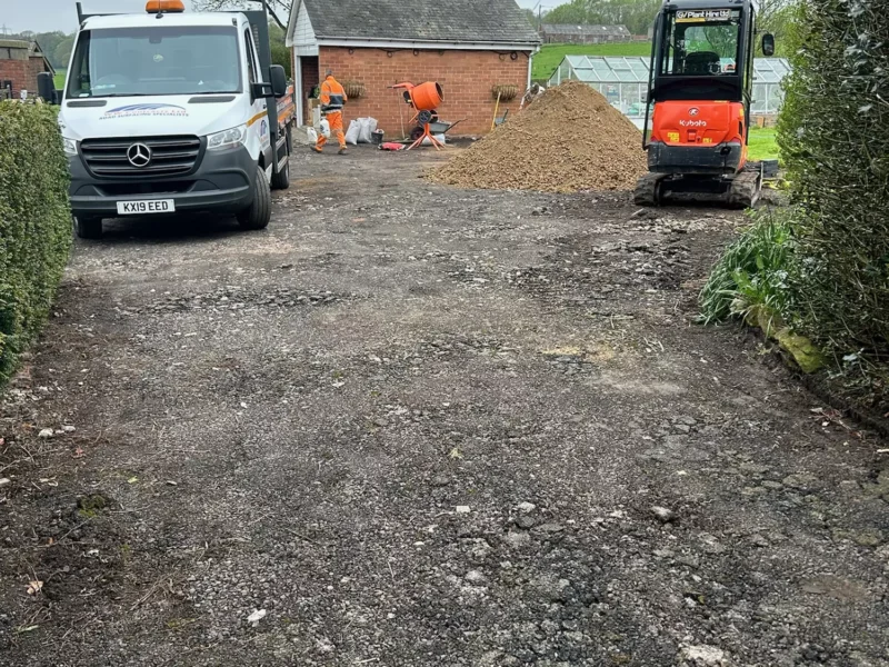 WW Contracts team removing old driveway in front of garage