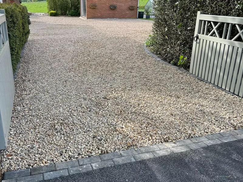 Close up of finished gravel driveway leading to a garage