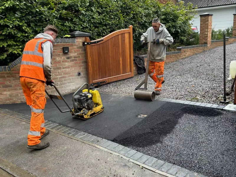 WW Contracts workers installing a tarmac entrance to a gravel driveway