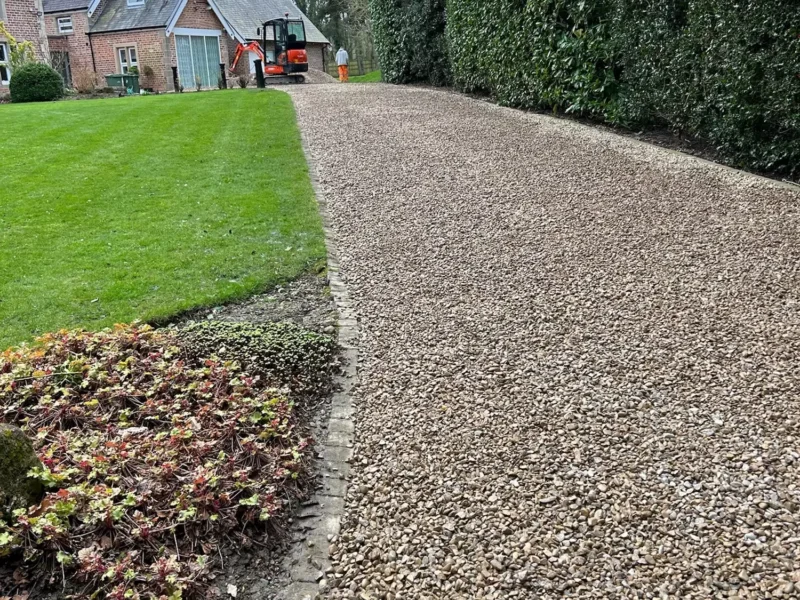A newly installed gravel driveway leading up to residential home