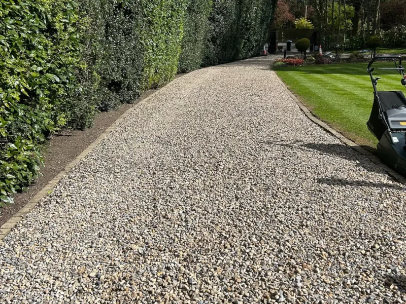 Gravel road leading up to a large residential property