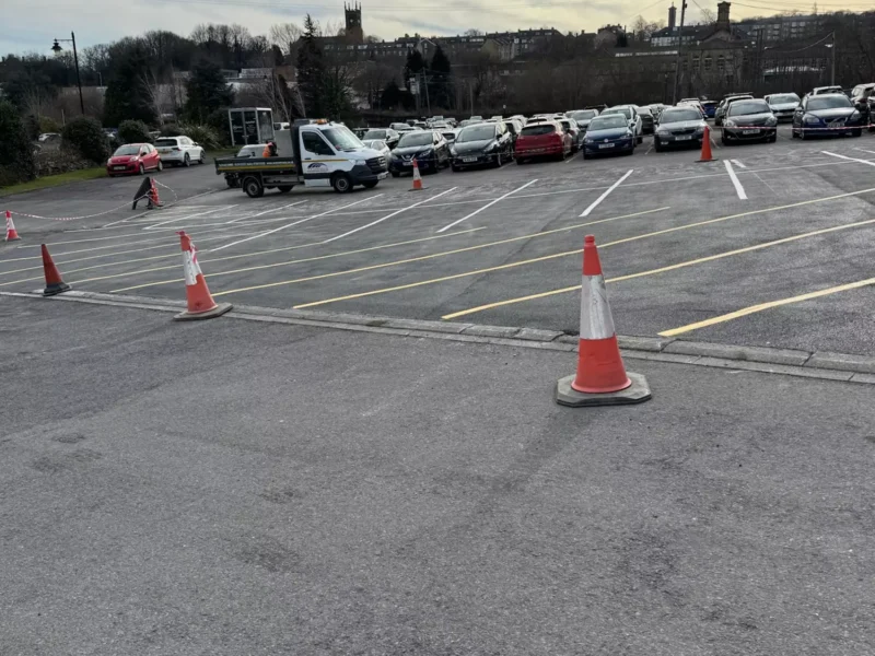 Newly painted car park marking in a car park with traffic cones in the foreground