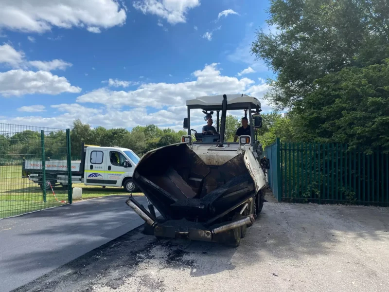 Paving vehicle laying new tarmac road
