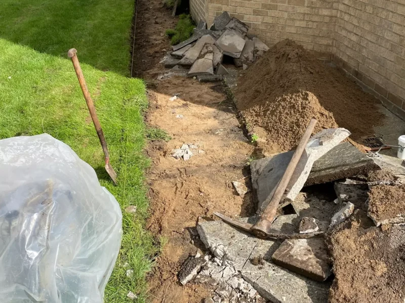 Old paving slabs being removed in front of community centre