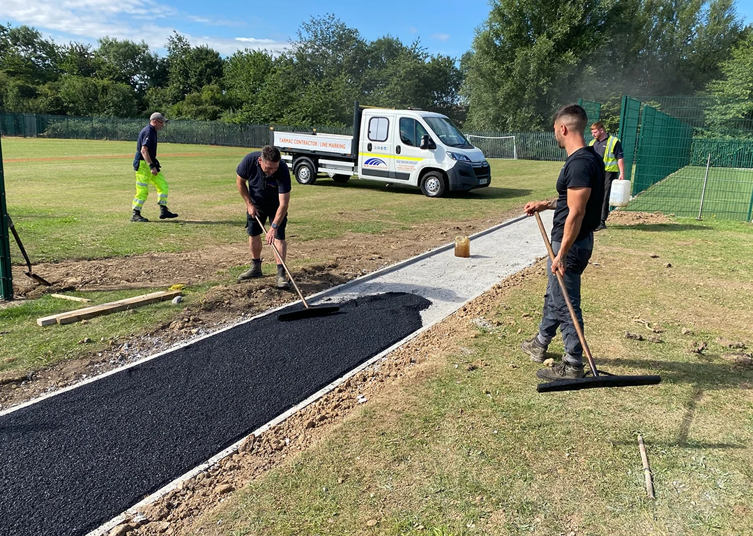 Workers from WW Contracts installing a new tarmac path