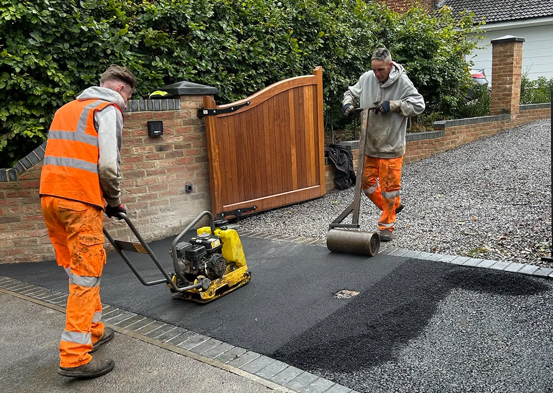 WW Contracts workers installing a tarmac entrance to a gravel driveway