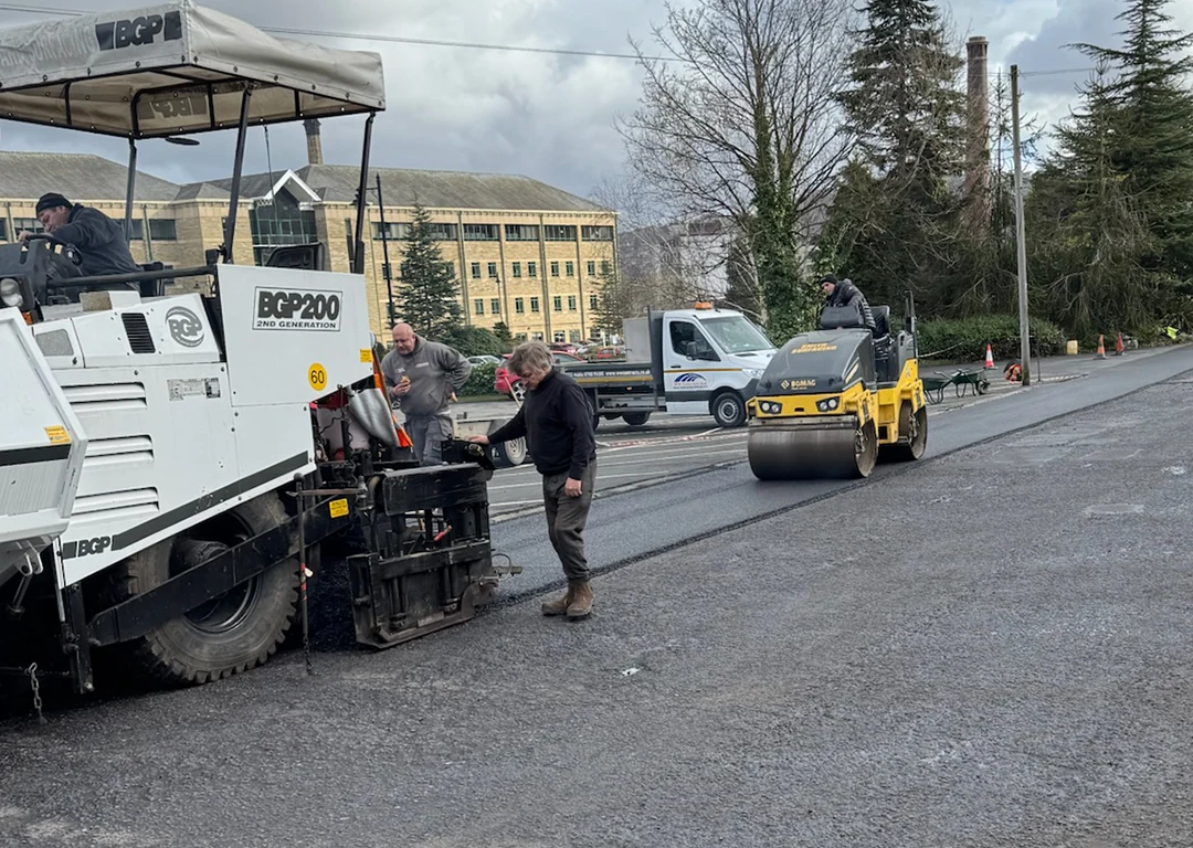 Road resurfacing in progress with a roller